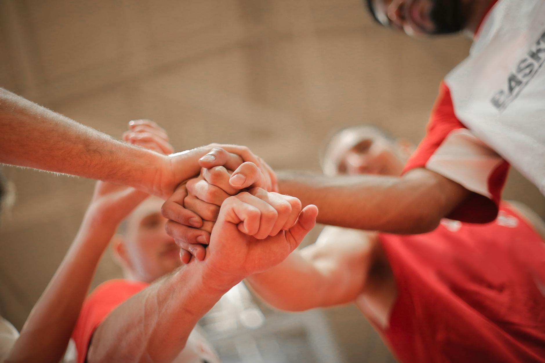 Photo by Andrea Piacquadio on https://www.pexels.com/photo/basketball-team-stacking-hands-together-3755440/
